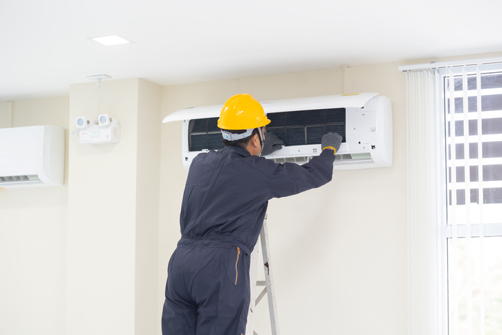 The mechanic Technician are Repairing Air Conditioner. And Surrounding Area | Fraley Heat & Air